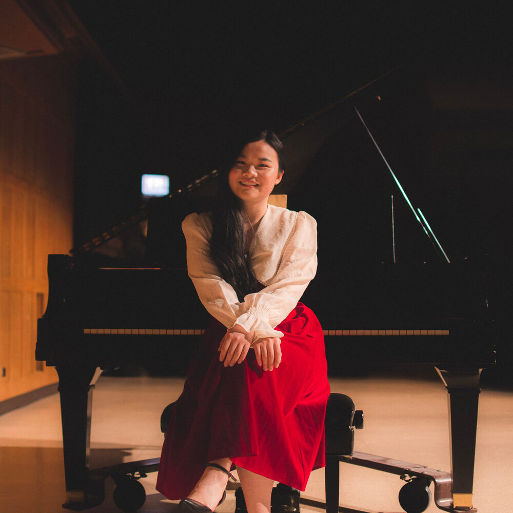 Song Chen seated at a grand piano